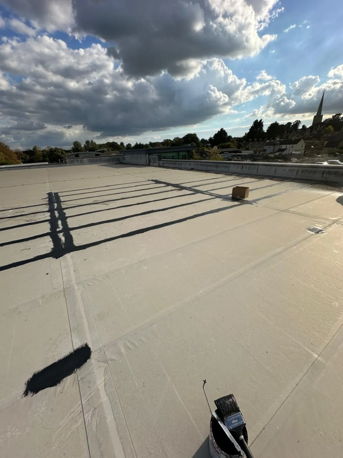 Wide view of roof membrane repairs and waterproofed joints at a Waitrose store in Oundle
